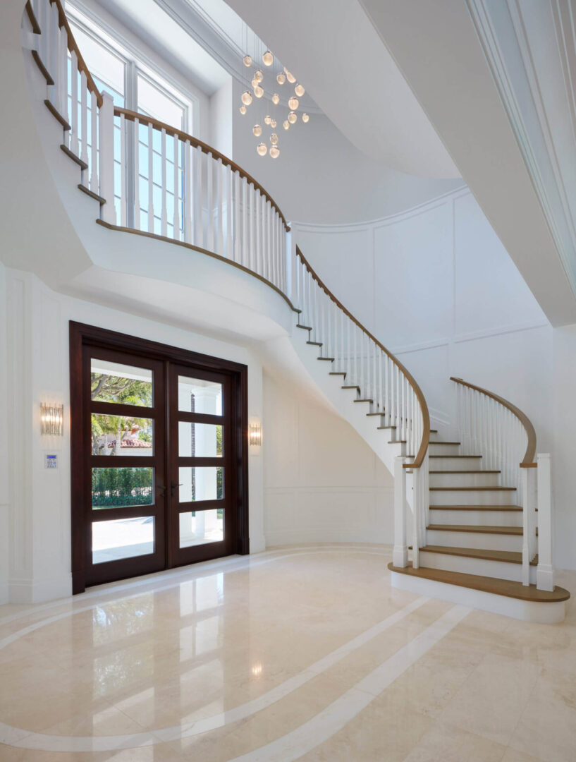 A large foyer with two doors and a staircase.