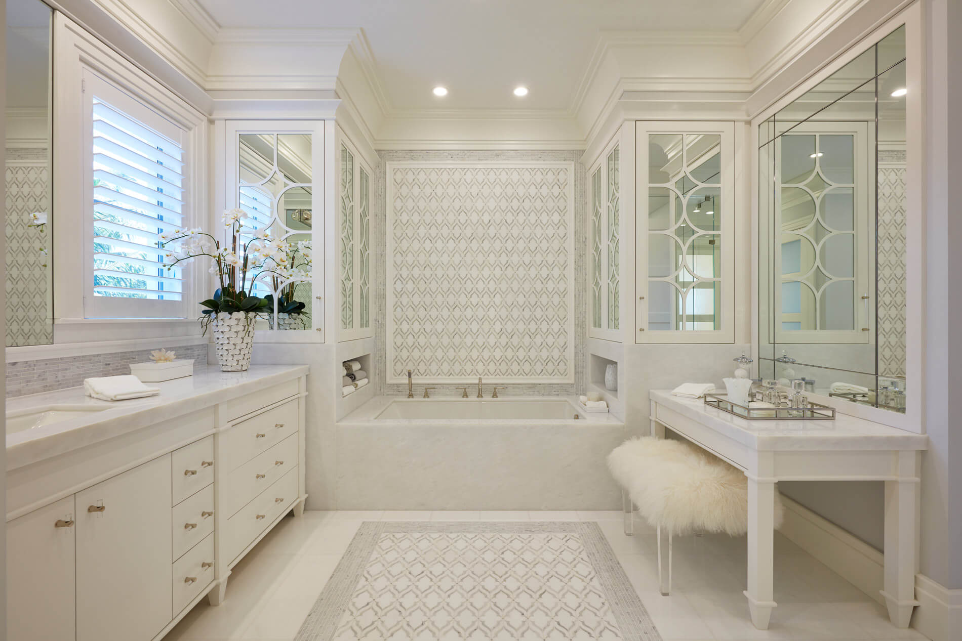 A white bathroom with a tub and sink