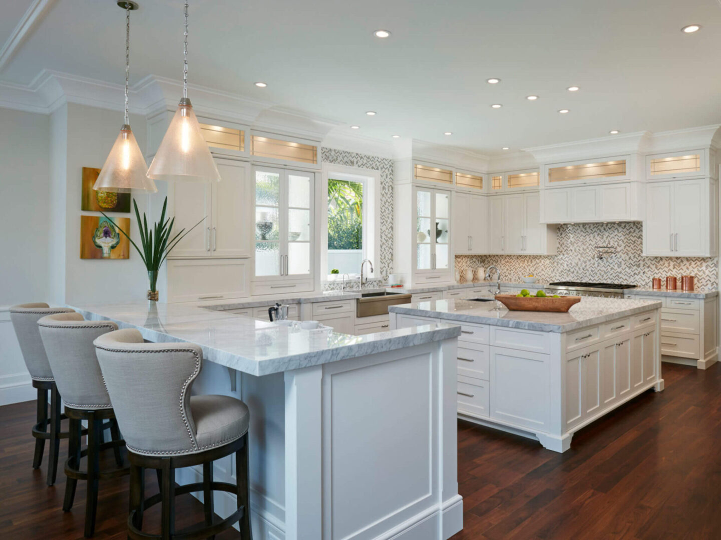 A kitchen with white cabinets and wooden floors