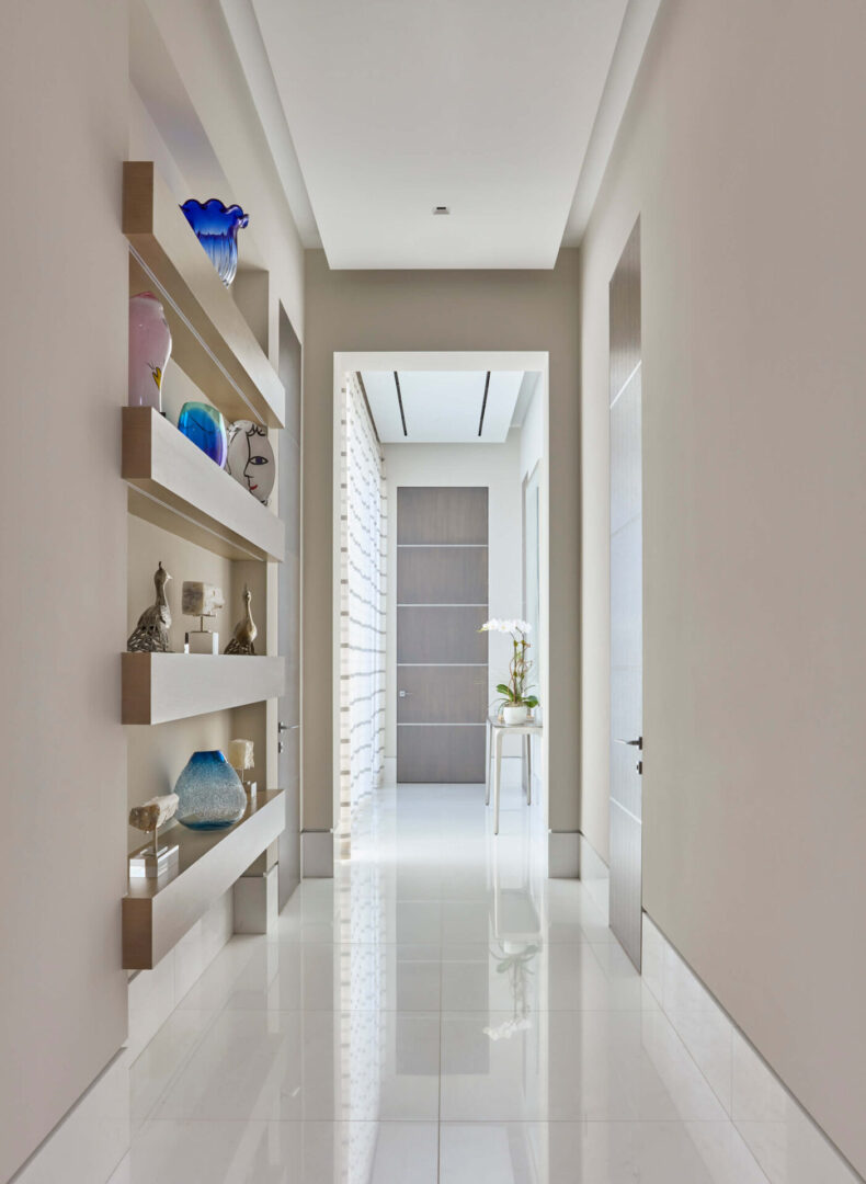 A hallway with shelves and a white floor