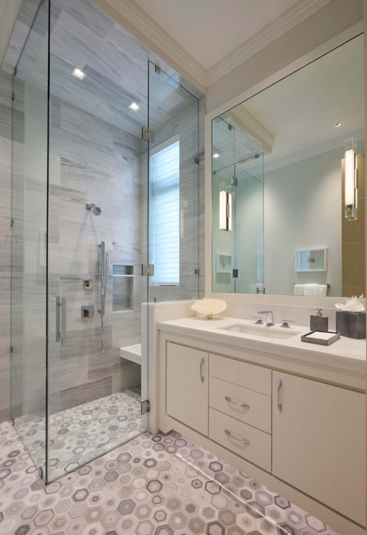A bathroom with a large walk in shower and a sink.