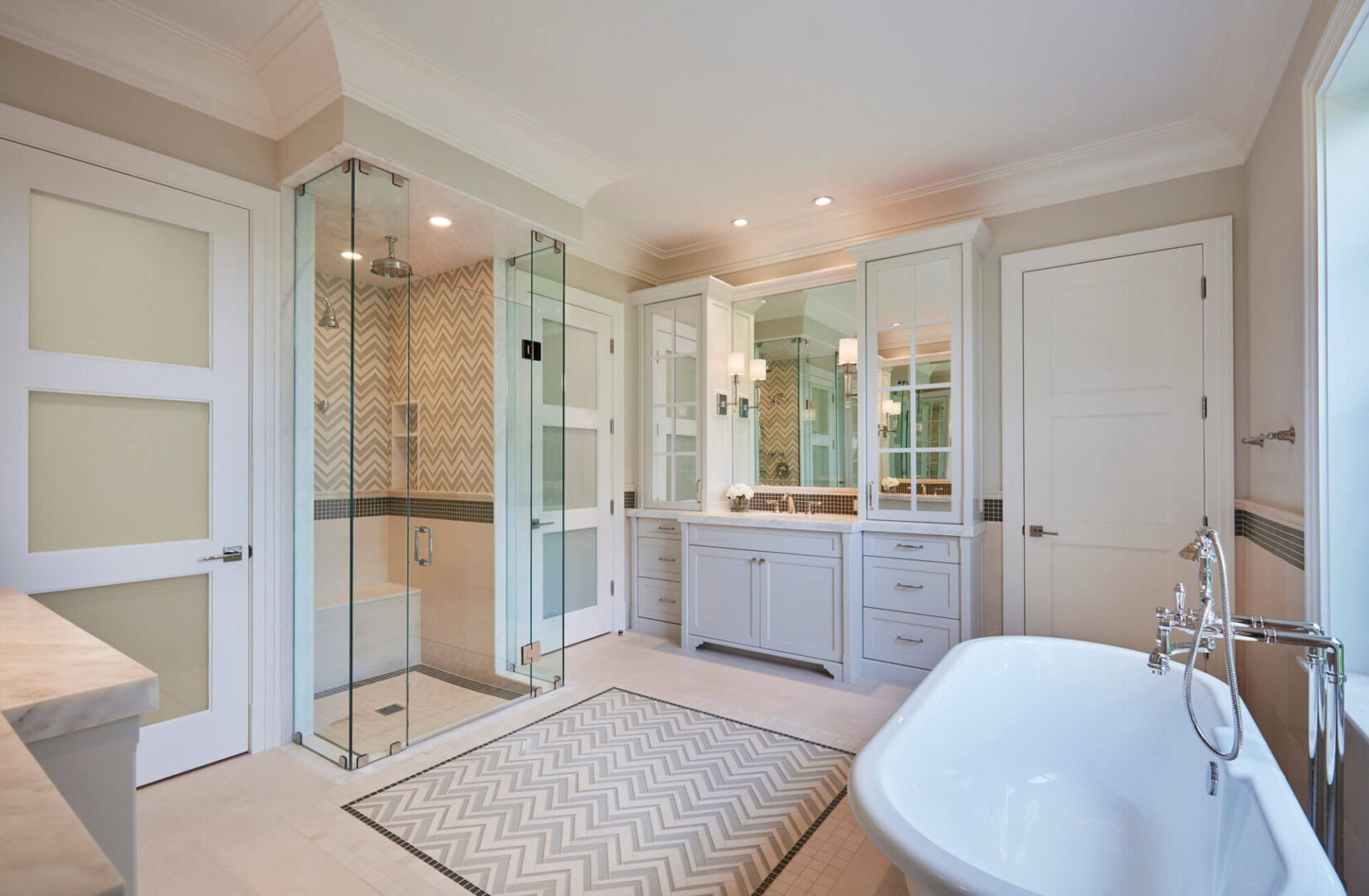A bathroom with a large mirror and a bath tub.