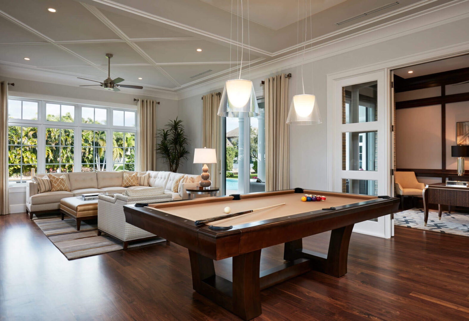 A pool table in the middle of a living room.