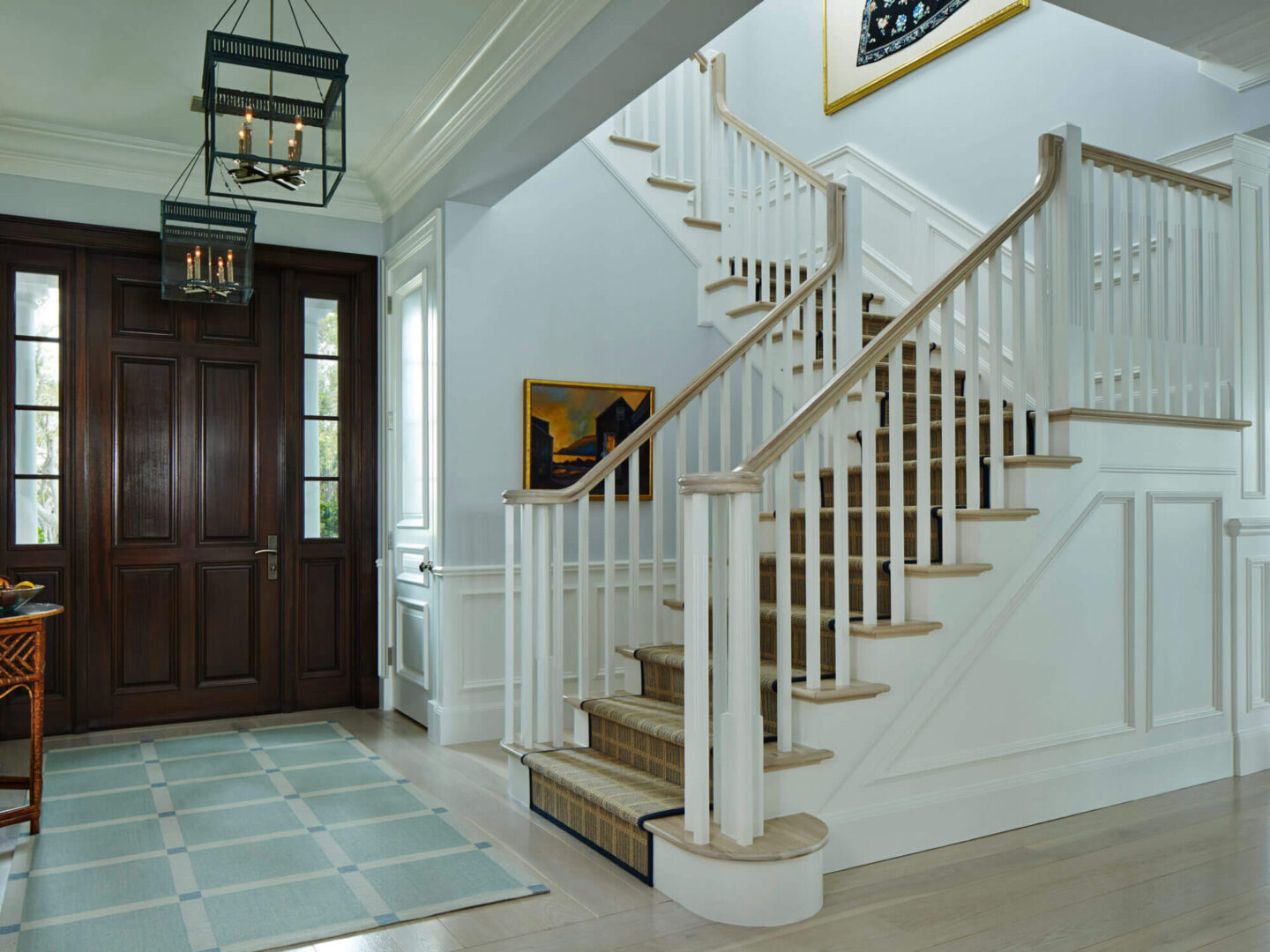 A white staircase with wooden steps and handrails.
