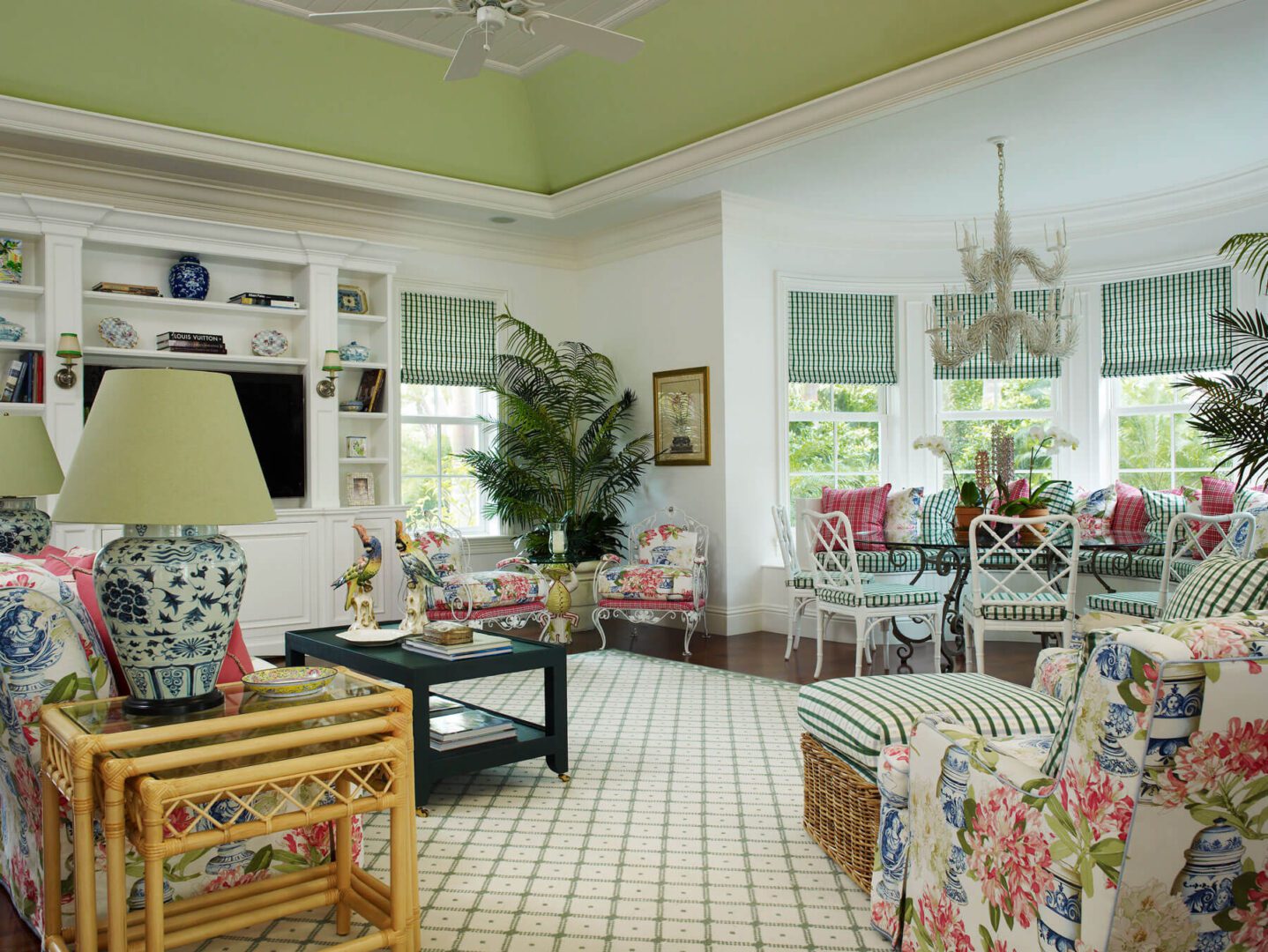 A living room with green walls and white ceiling.