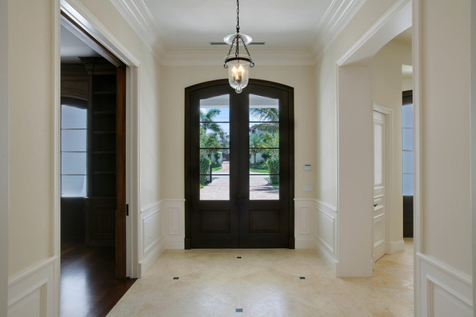 A large entry way with two doors and a light fixture.