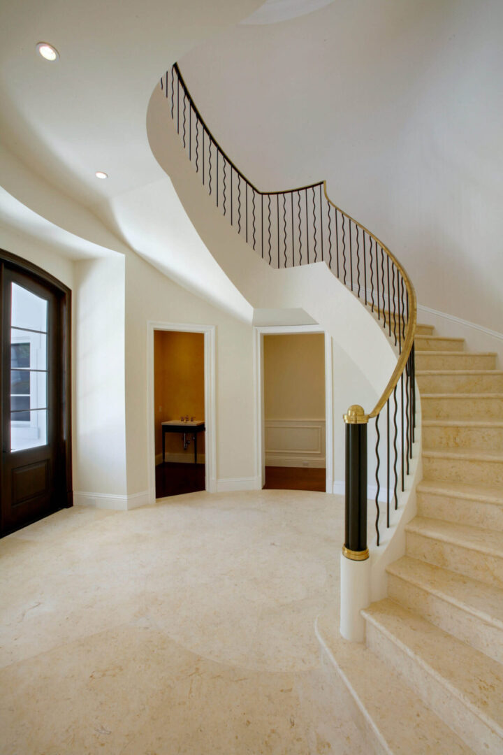 A large room with stairs and a door.