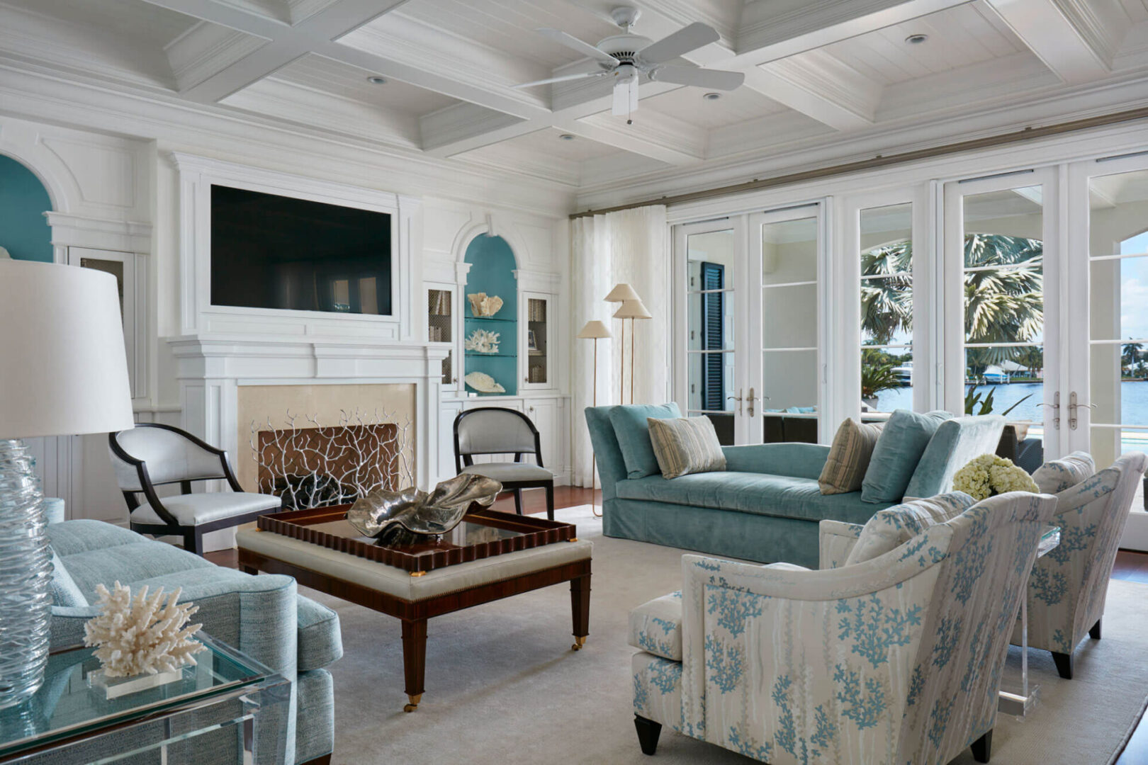 A living room with white walls and blue furniture.
