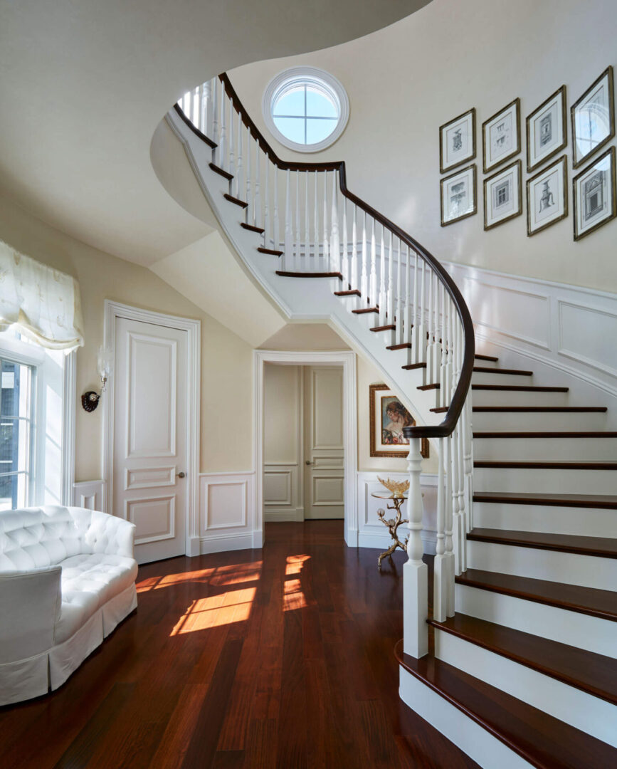 A white staircase with wood steps and wooden handrails.
