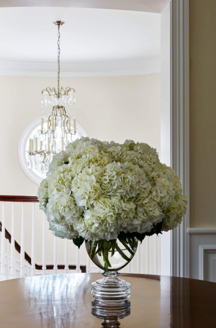A large white flower arrangement in the middle of a staircase.