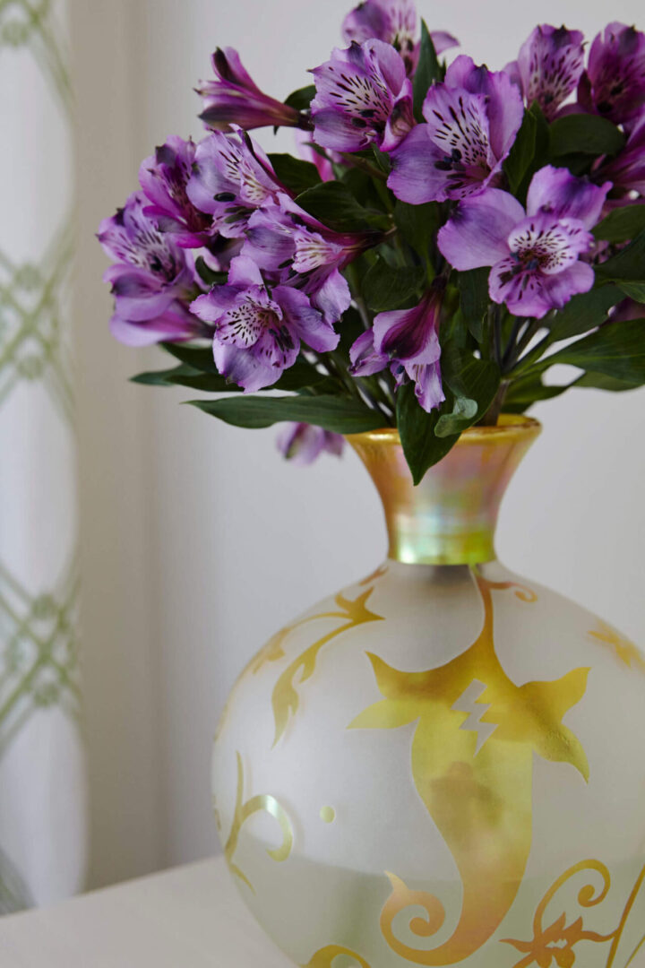 A vase with purple flowers in it