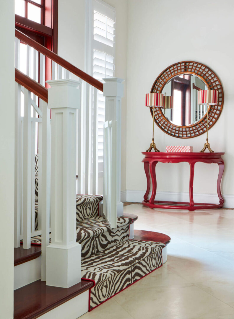 A room with a zebra print chair and red table