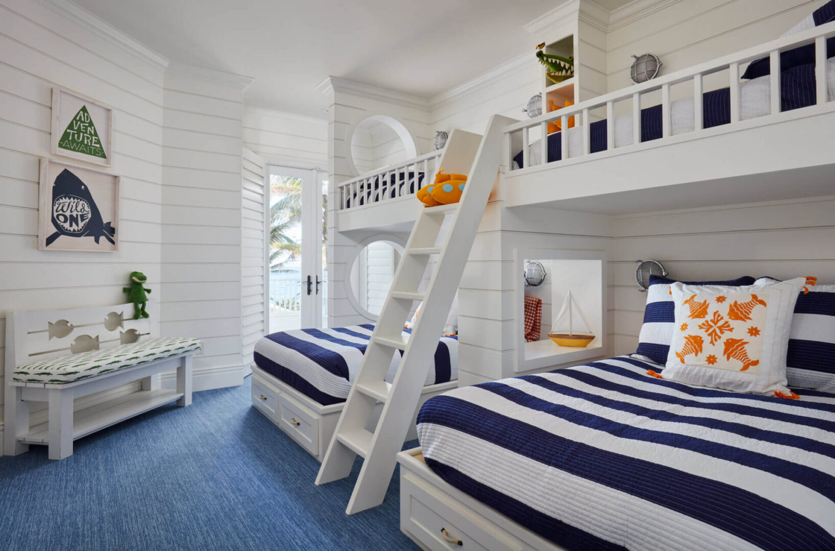 A room with two bunk beds and stairs.