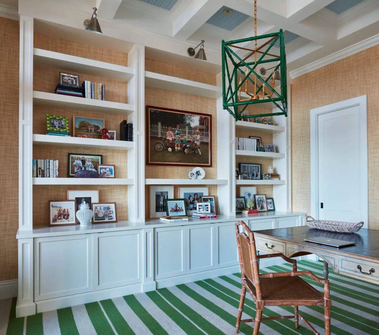 A room with green and white striped floors, shelves and a table.