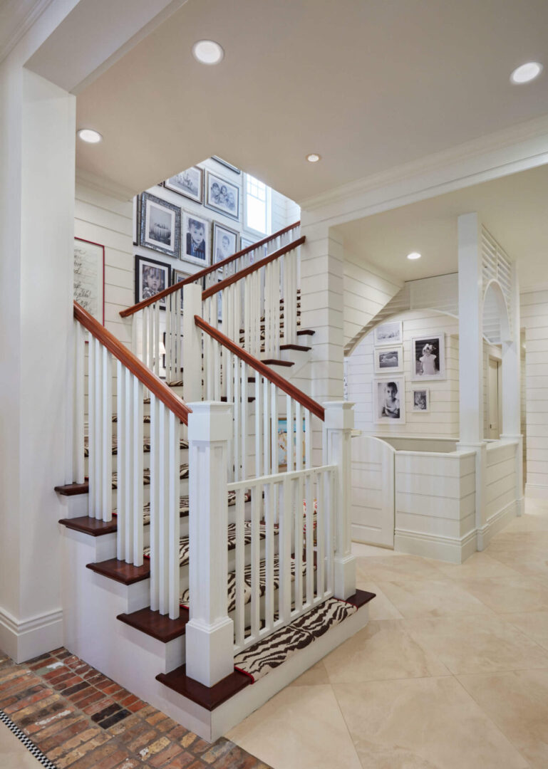 A white staircase with wooden handrails and steps.