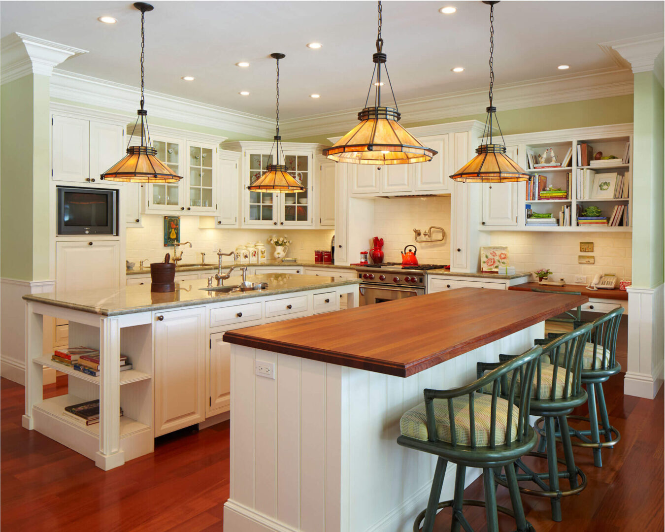 A kitchen with two large wooden stools and a counter.
