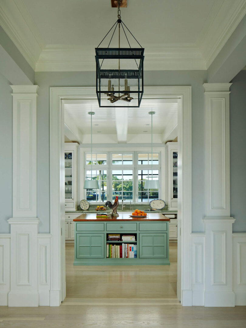 A kitchen with white walls and blue cabinets.