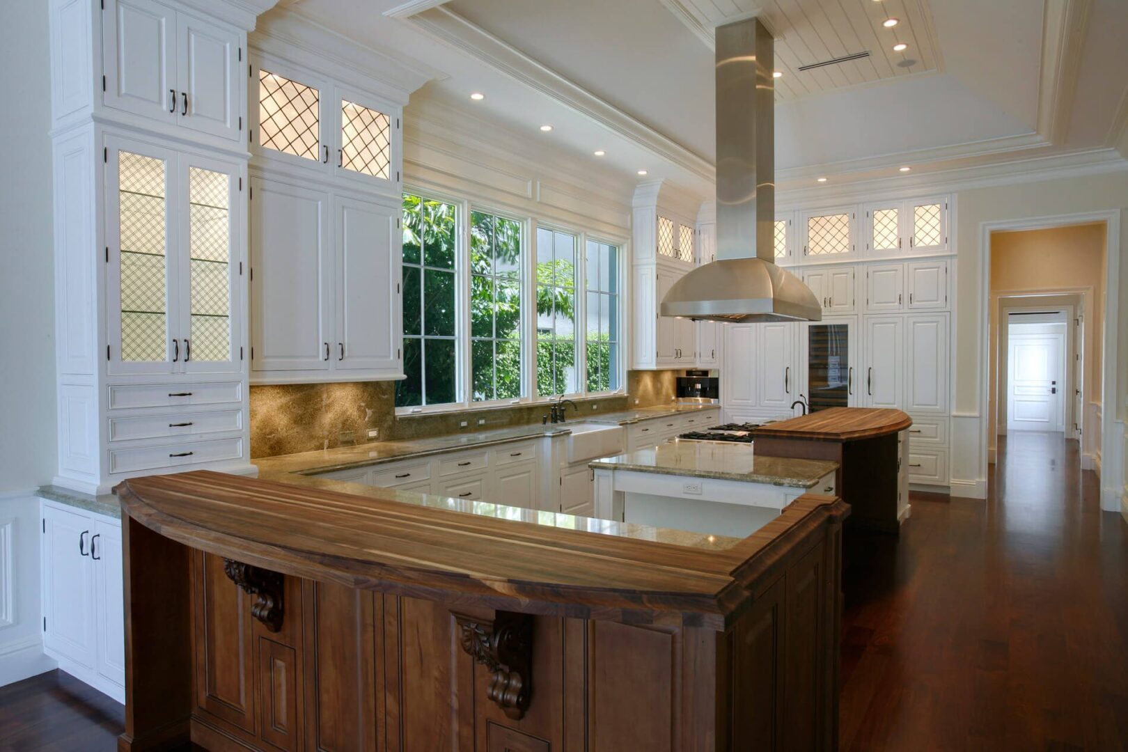 A kitchen with wooden cabinets and white walls.