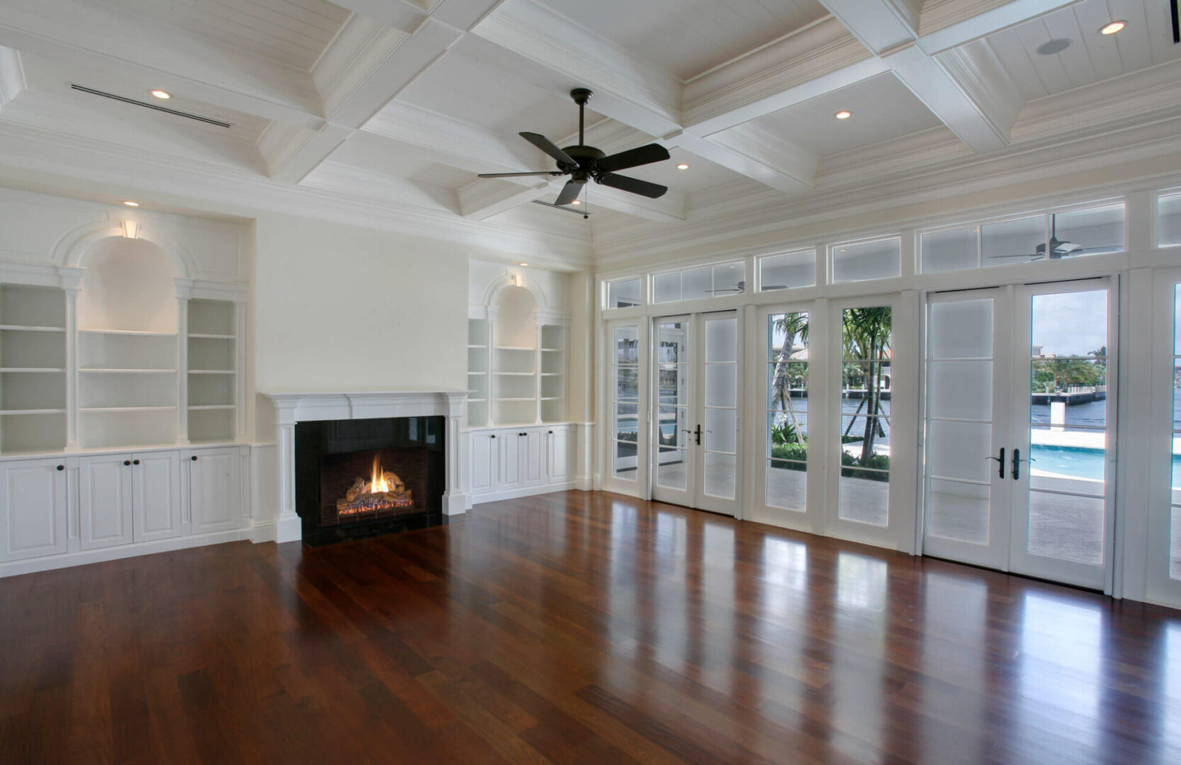 A living room with hard wood floors and white walls.