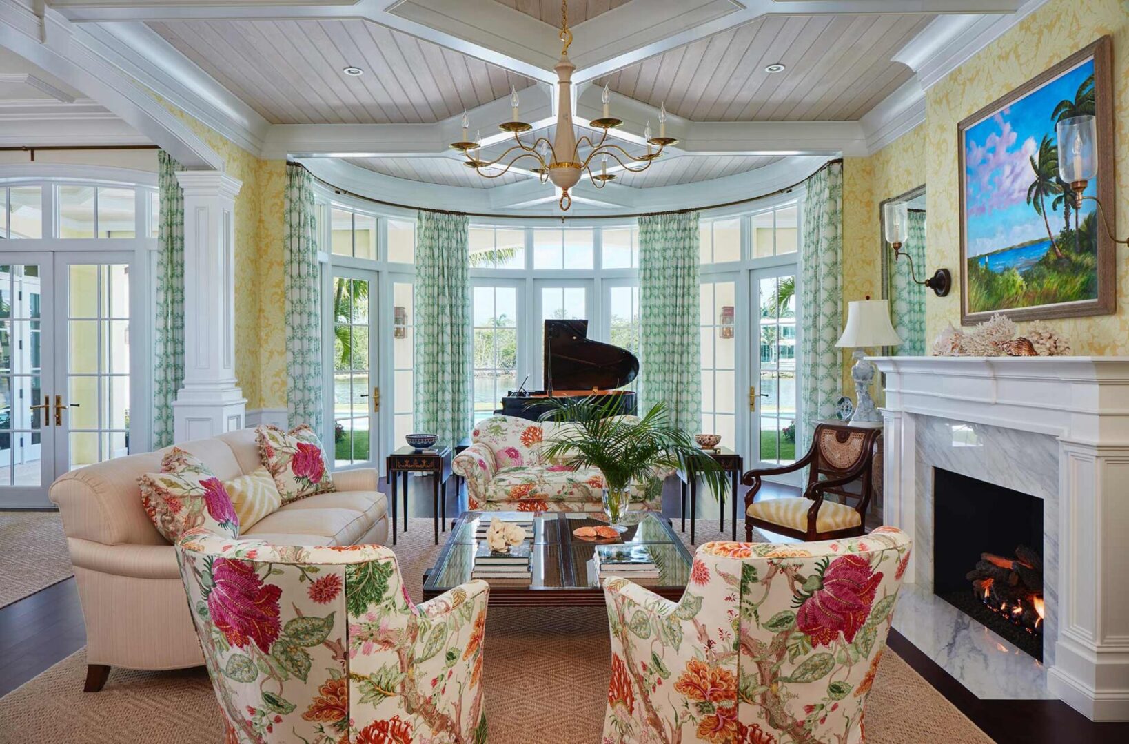 A living room with floral furniture and a piano.
