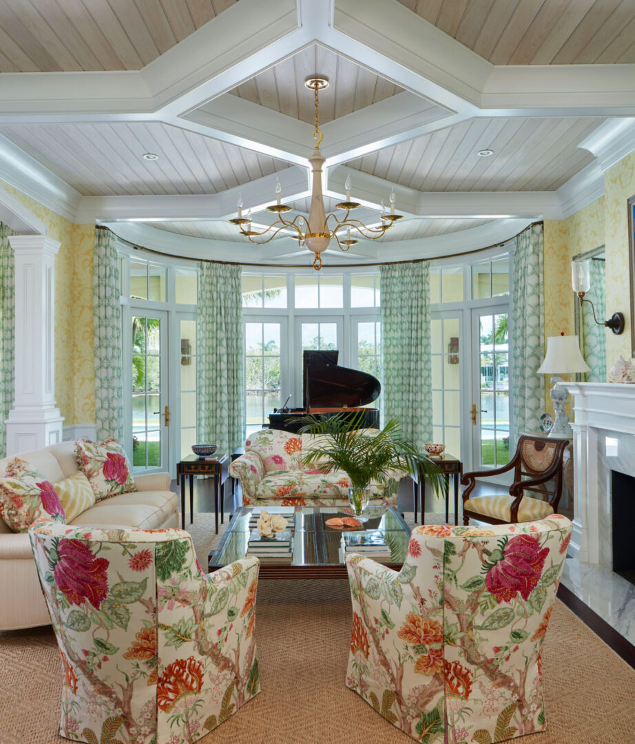A living room with floral chairs and a piano