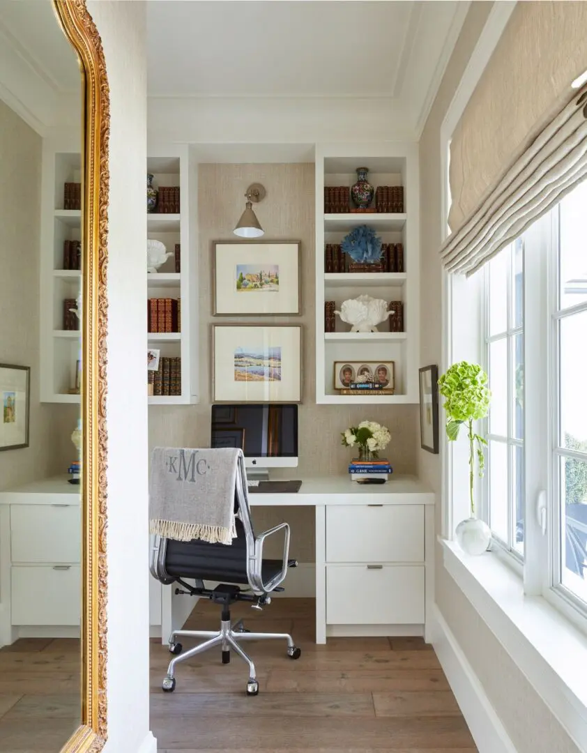 A home office with two desks and a chair.