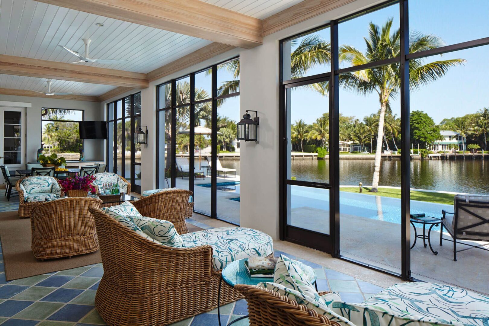 A living room with sliding glass doors and palm trees.