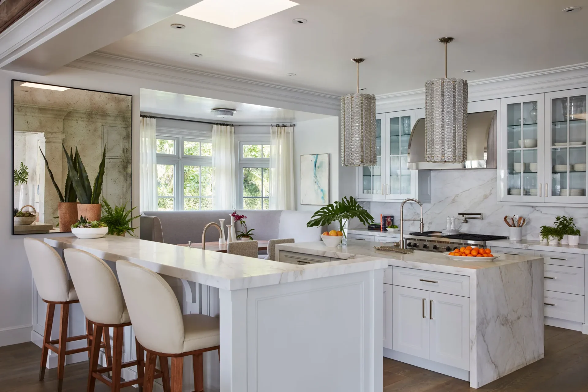 A kitchen with white cabinets and a large island.