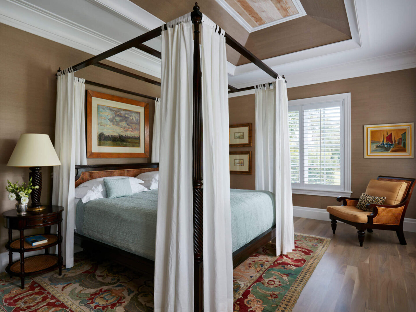 A bed room with a four poster bed and a window