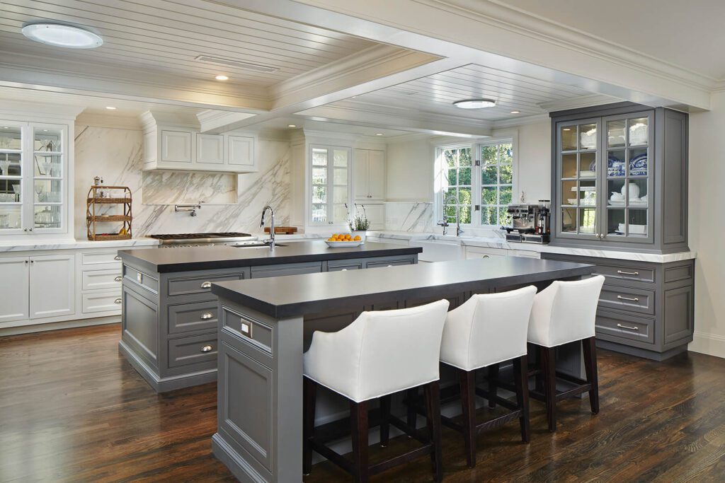 A large kitchen with white chairs and a big island