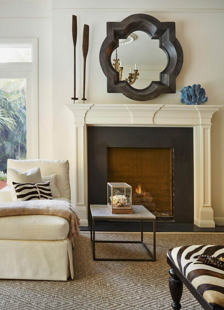 A living room with a fireplace and a mirror