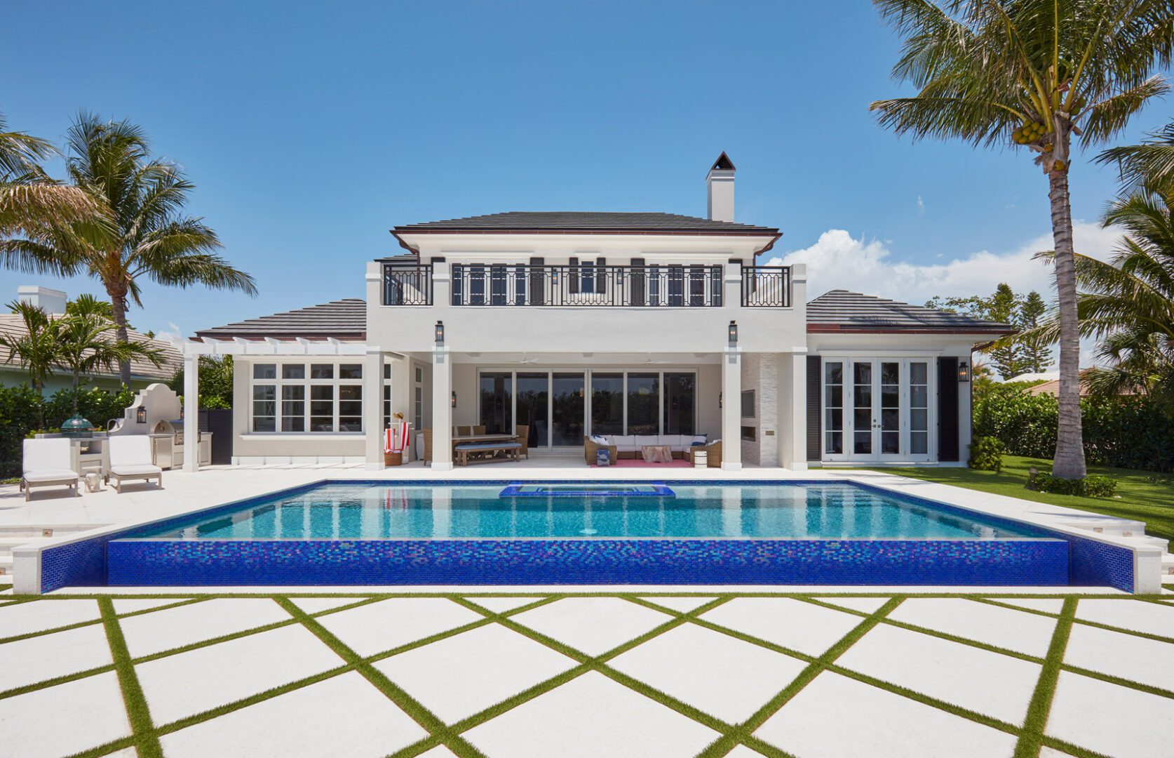A large white house with a pool in the middle of it.