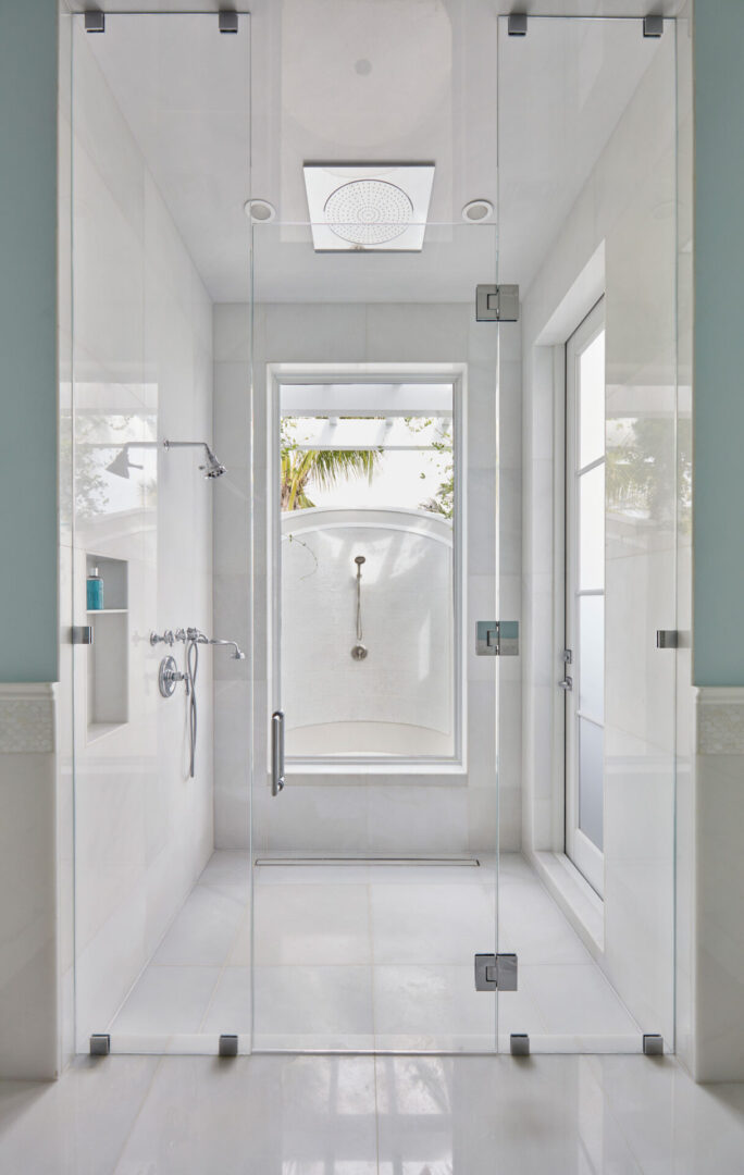 A bathroom with a shower and tiled floors.