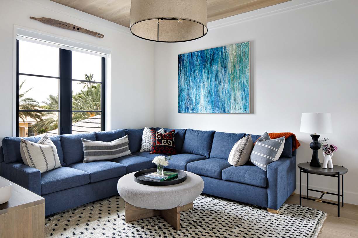 A living room with blue furniture and a white coffee table.