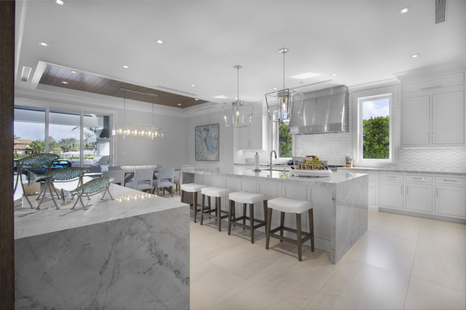 Modern kitchen with island and bar stools.