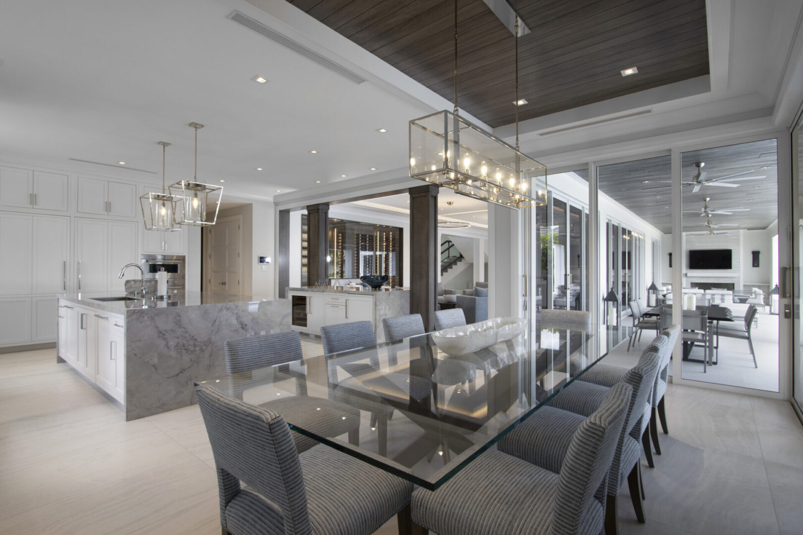 Modern dining room with glass table and chairs.