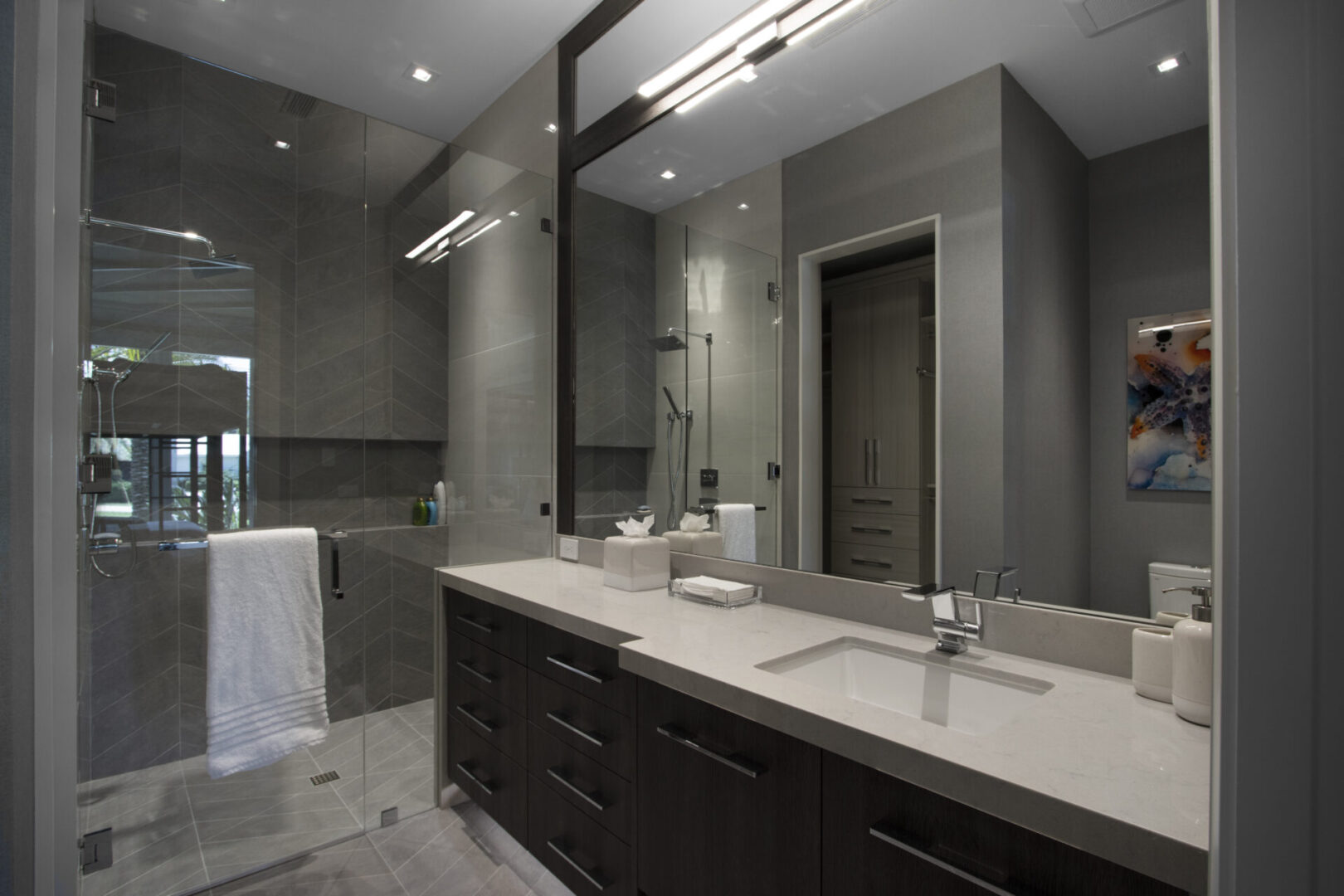 Modern bathroom with a glass shower and vanity.