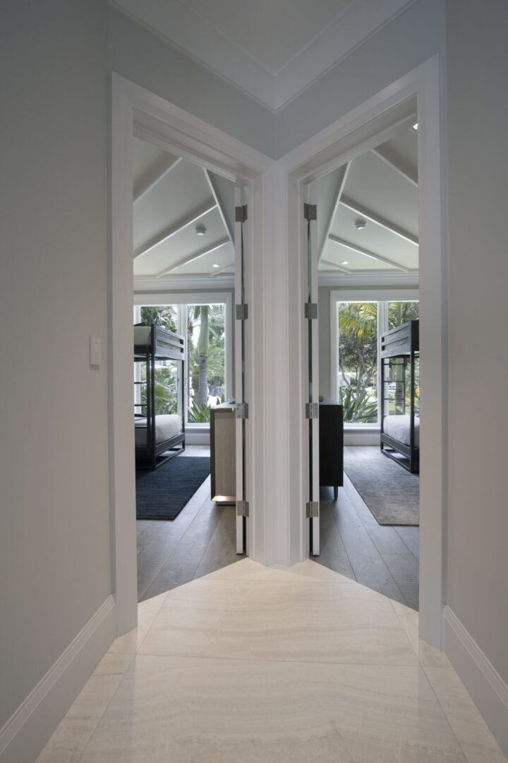 Hallway with two open doors leading to bedrooms.