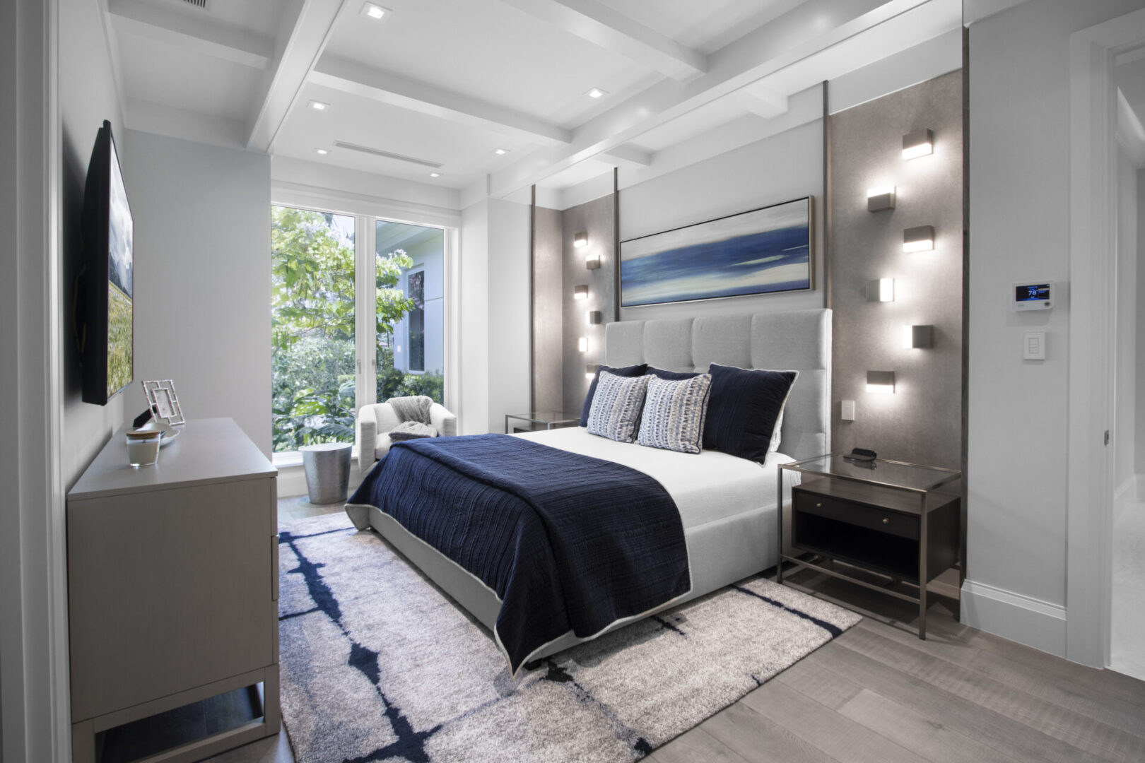 Modern bedroom with a blue and white bed.