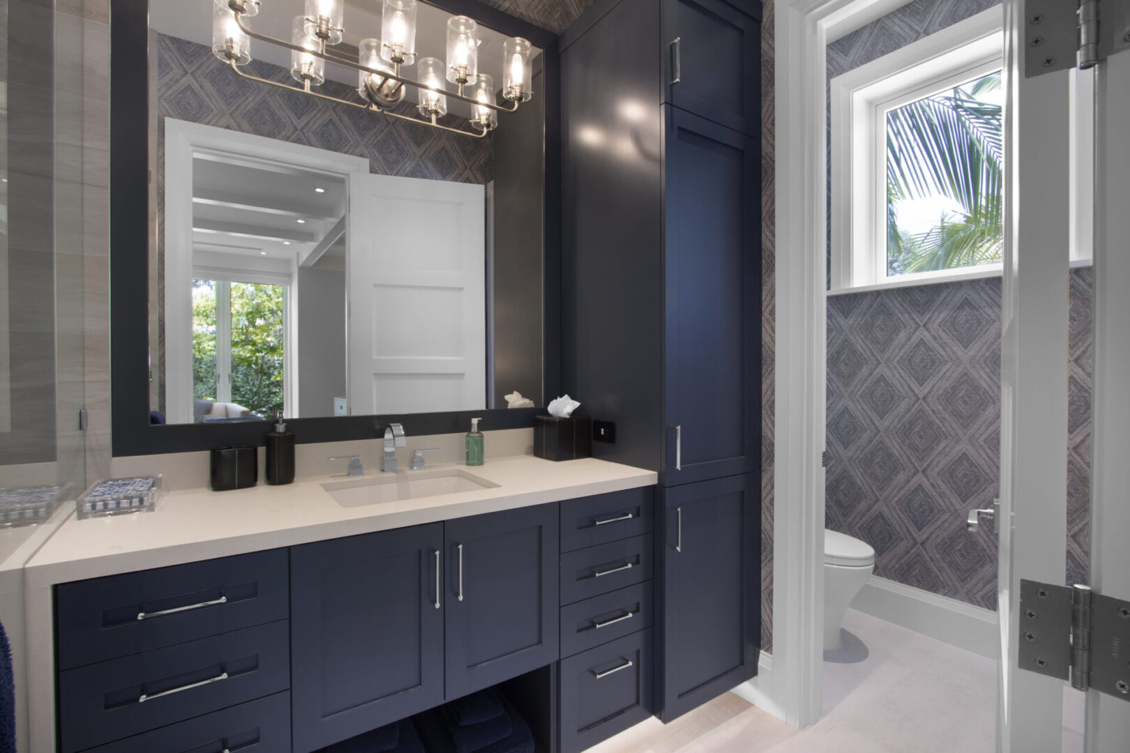 Bathroom vanity with mirrored cabinet and toilet.