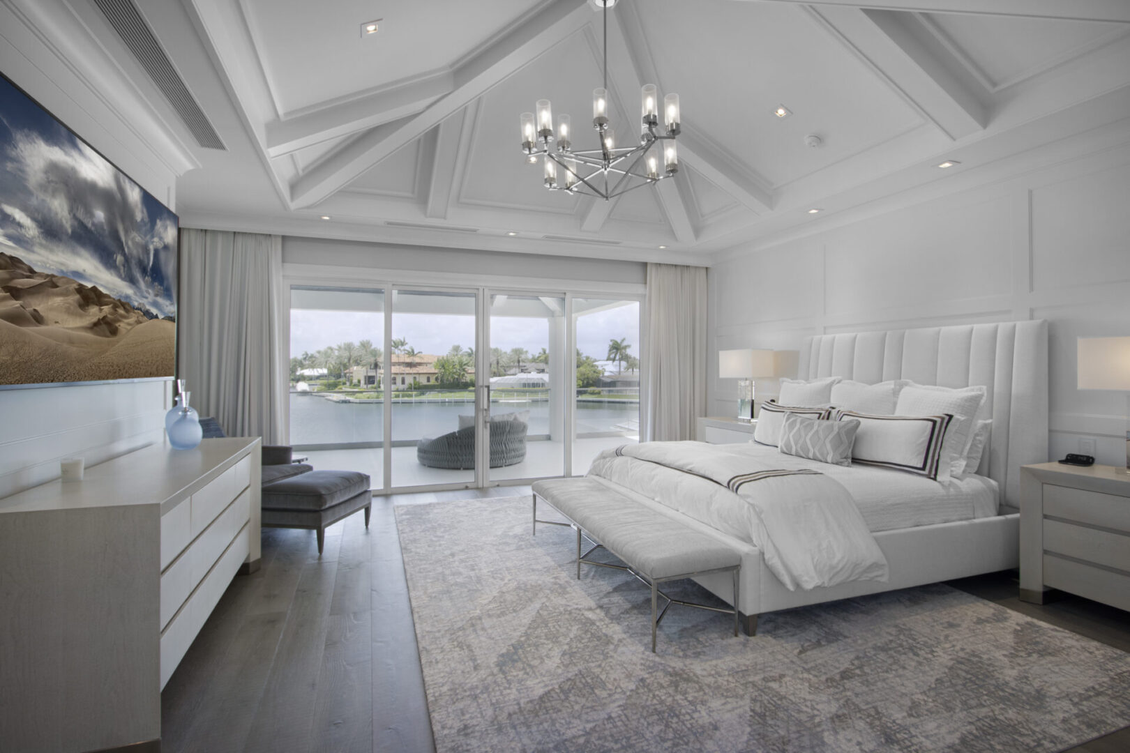 Luxury waterfront bedroom with king bed.