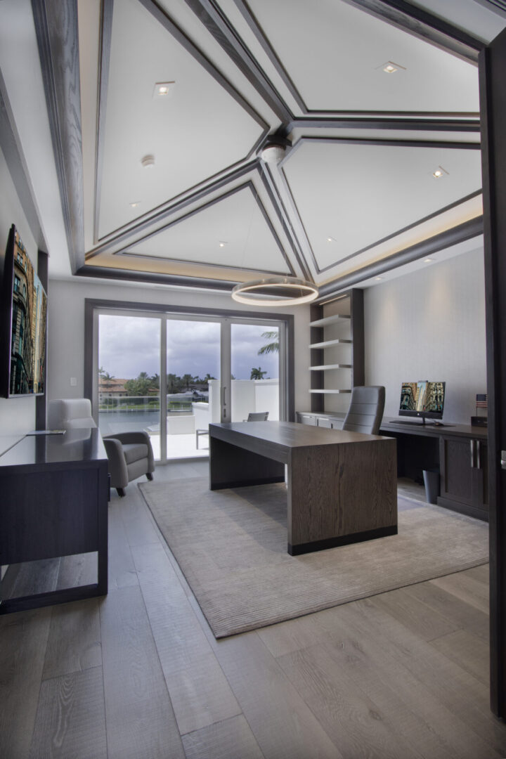 Modern office with a view and a geometric ceiling.