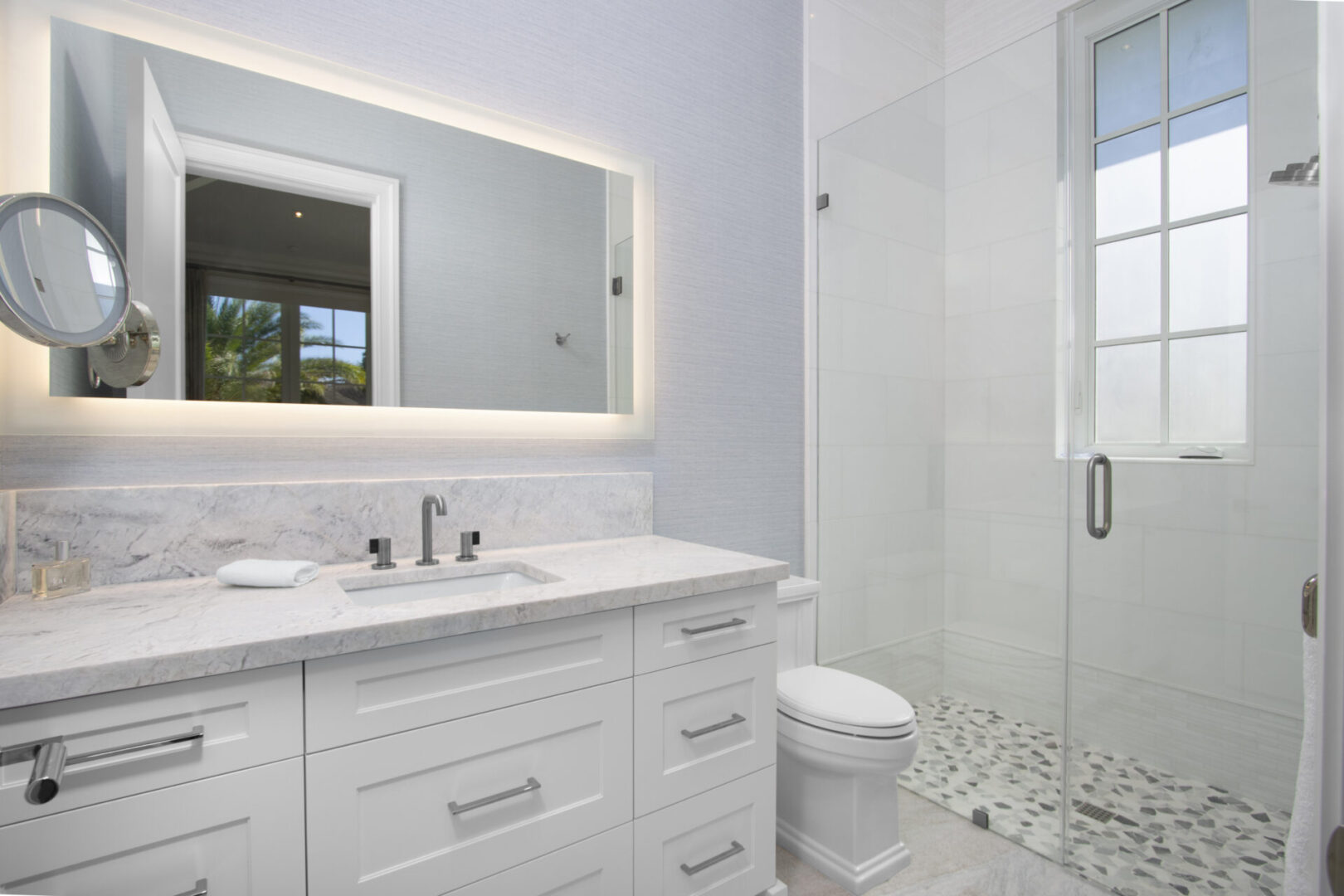 White bathroom vanity with a sink and mirror.