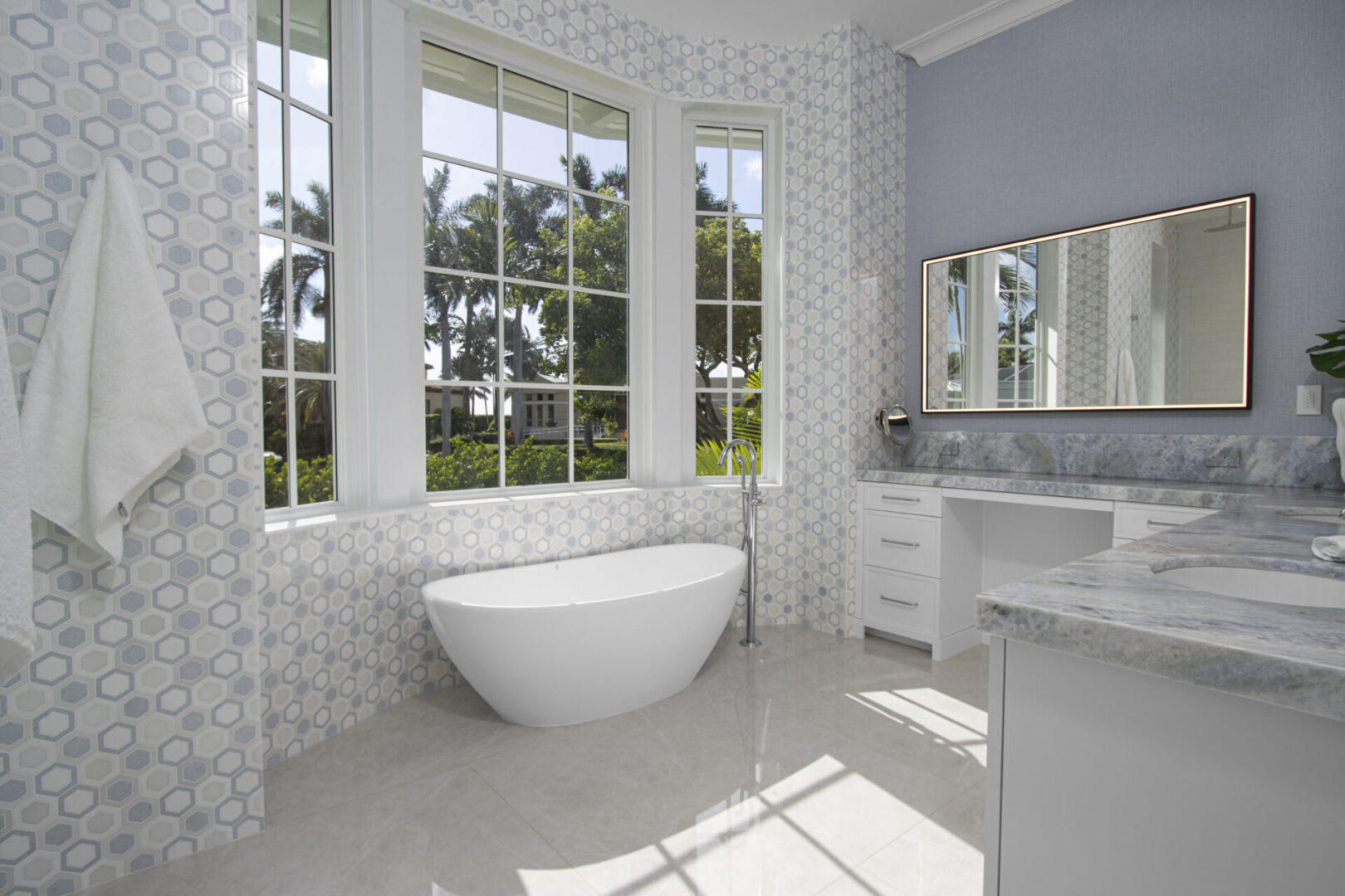 Modern bathroom with white bathtub and tile.