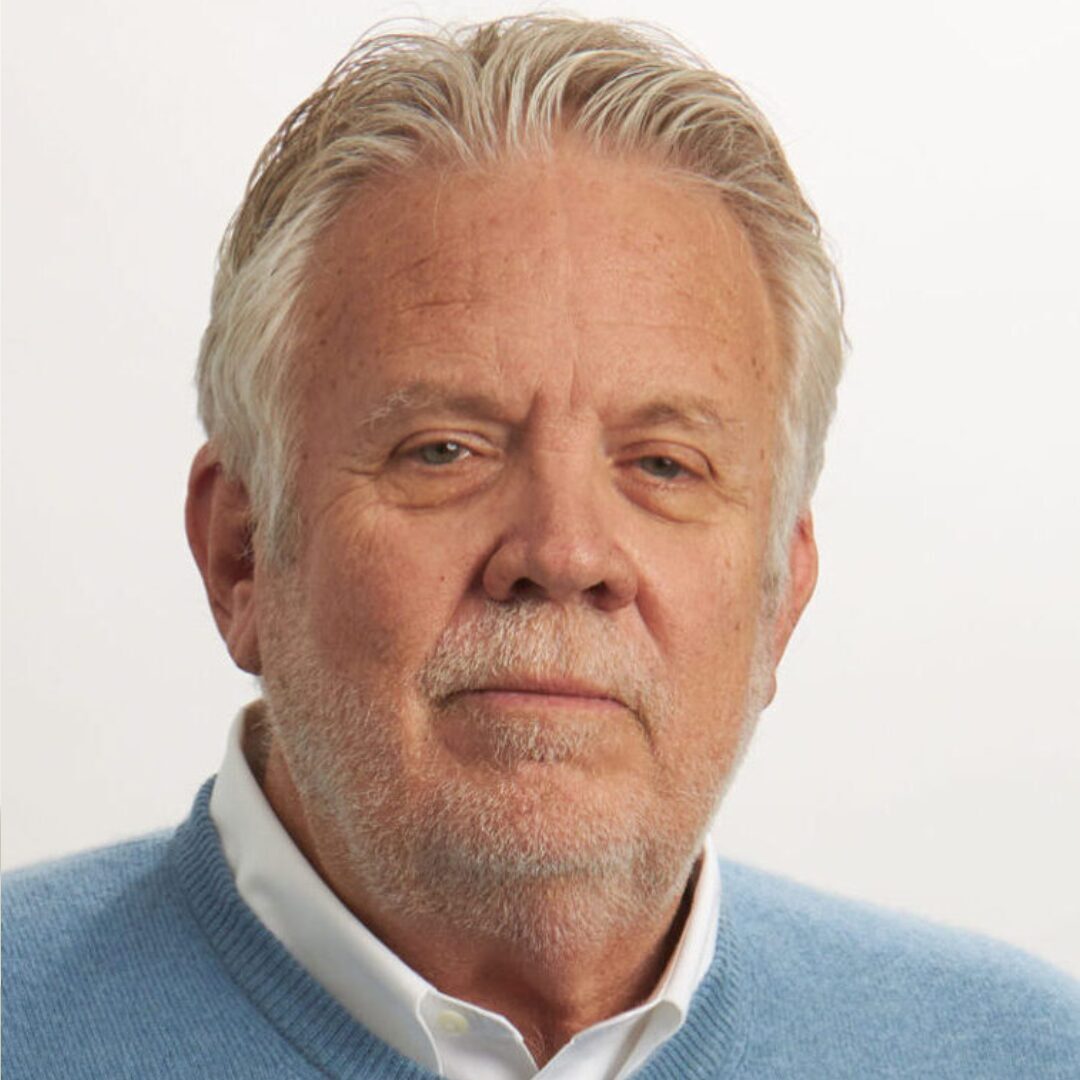 Portrait of an older man with grey hair.