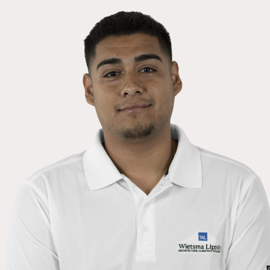 Man in white polo shirt with logo.