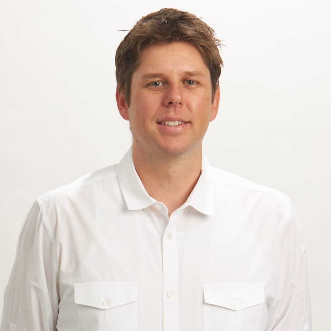 A man in white shirt and brown hair.